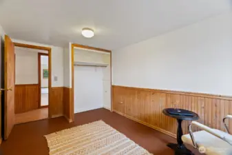 Another view of the additional bedroom with beautiful wood paneling ...