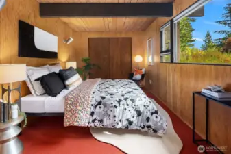 This beautiful 3rd bedroom is warm, cozy, and inviting, with a large south-facing window and tall ceilings making it anything but "basementy."