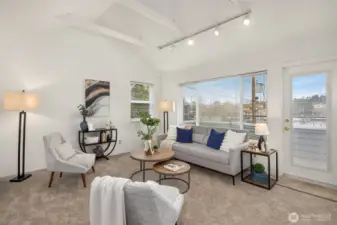 The family room has a wall of windows that illuminate the space with natural light. Convenient patio access is perfect for enjoying your morning cup of coffee.