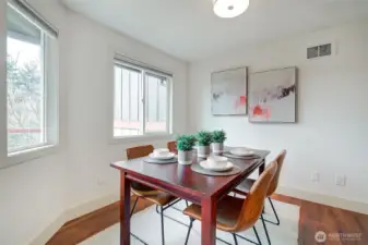 The dining room view overlooks the tree lined scenery surrounding this home.