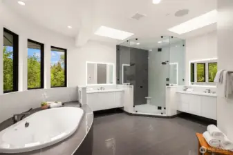 Amazing spa-inspired bathroom featuring a soaking tub, dual vanities, a walk-in shower and heated floors! Don't miss the walk-in closet with a butler's elevator for easy lifting between floors!