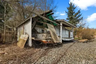 The boat cover is on this property. The cabin next to it is on the neighboring parcel. See attached Survey