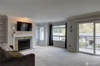 Large open Living Room  with wood fireplace, built in shelving