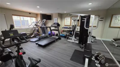 Fitness room with treadmill, excercise bike, weights, elyptical and showers