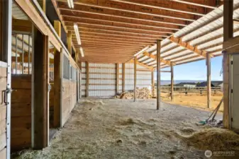 Inside the 4-stall barn there is an open area to tack up or store hay.  The lights make it easy to use year round!