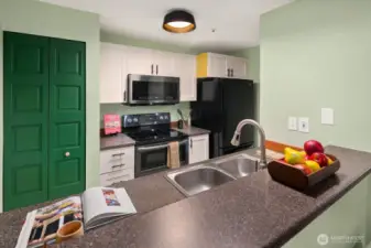 Open living/dining/kitchen w/ slider opening to patio & yard space