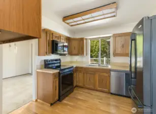 Kitchen with hardwood floors and smart appliances