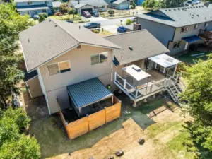 View of deck, patio, and another smaller shed at side of house