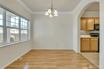 Dining room just off the kitchen with big picture window for natural light, crown moulding for an elegant feel ~