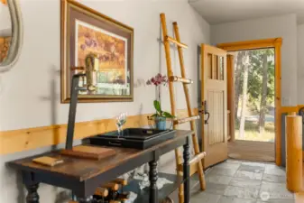 Welcoming entry with slate tile flooring and warm wood accents, setting the tone for the home’s lodge-style character.