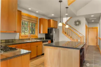 Generous kitchen with custom cabinetry and ample storage. Expansive counters provide space for cooking and gathering.