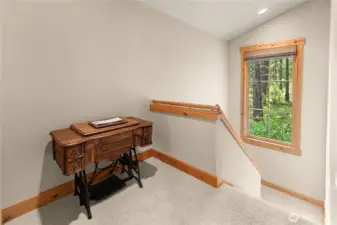 Sunny landing at the top of the stairs – ideal spot for a cozy reading nook or small home office with forested views.