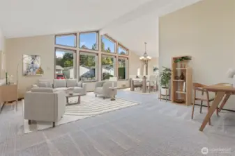 Formal living room with vaulted ceilings, new wall to wall carpet and fresh paint.  Wall of windows provides year round natural light- Virtually staged photo.