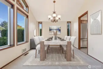 Formal dining room with vaulted ceilings opens to formal living room and the kitchen.  Virtually staged photo.