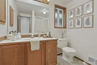 Hallway 2nd bathroom with walk in shower.   Virtually staged photo