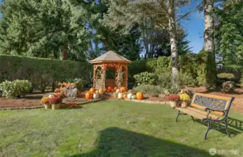 Private landscaped back yard with a gazebo- Virtually staged photo.