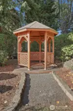 Private landscaped back yard with a gazebo