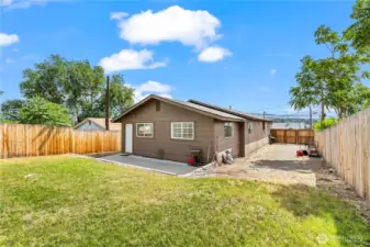 Rear of home, huge yard, extended driveway behind fence