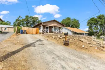 Large driveway with additional parking beyond the fench
