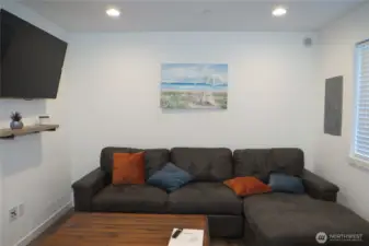 TO THE LEFT IN THE LIVING ROOM WHICH COMES FULLY FURNISHED!  THE COUCH PULLS OUT FOR ADDITIONAL SLEEPING, TELEVISION AND OTHER FURNISHINGS!