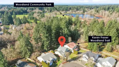 One of the home’s most extraordinary features is its direct backyard access to nature — a private gate opens to the lush HOA greenbelt property and leads straight to Woodland Creek Community Park and the scenic Karen Frazier Trail. Enjoy peaceful morning walks, evening strolls, playground access, and miles of wooded pathways right from your own backyard. This seamless connection to parkland and trail systems offers a rare blend of privacy, recreation, and everyday convenience — an exceptional lifestyle opportunity few homes can provide.