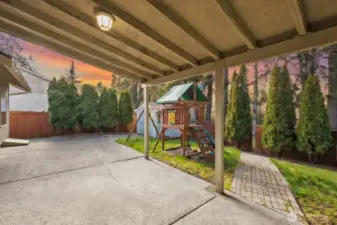 This backyard is more than a yard — it’s a lifestyle. A covered patio invites year-round gatherings and peaceful evenings, while a charming garden shed keeps everything neatly organized. The play structure adds a joyful touch, and tall evergreens create a serene, private backdrop. A private gate offers direct access to the trail and Woodland Creek Community Park, seamlessly connecting home to nature.