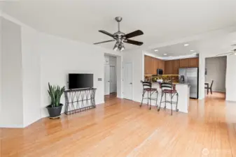 The Ultimate Layout. See how beautifully the kitchen interacts with the living spaces. This vantage point highlights the home’s circular flow, keeping the chef connected to the action in the family room and ensuring a bright, airy feel throughout the day.