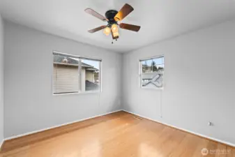 Versatile Spaces. This bright third bedroom features dual-aspect windows, making it an ideal candidate for a quiet home office or a sunny hobby room. The neutral palette is ready for your personal touch.