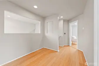 Architectural Detail. The spacious upper landing features a unique architectural cut-out that overlooks the living area below, maintaining an open connection between floors. This versatile space could easily accommodate a small reading nook or workstation.