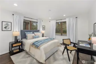Bright and welcoming main-level guest bedroom offers abundant natural light and a comfortable retreat for visitors.