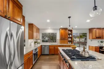 Spacious kitchen featuring a large island with seating, abundant storage, and a convenient pass-through to the dining room, ideal for effortless entertaining.