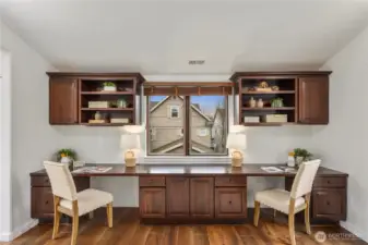Beautifully designed home office with two Juliet balconies, built-in desks, and custom shelving, an inspiring space for working from home.