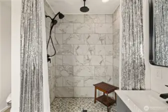 Large shower with multiple shower heads.