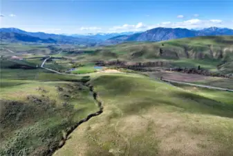 Classic dryland hillside rolls down to Upper Beaver Creek Road and to Driveway of 109 Upper Beaver Creek Road, Twisp.