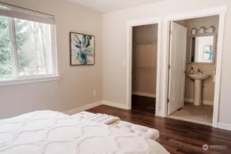 Primary bedroom with walk in closet and private bathroom