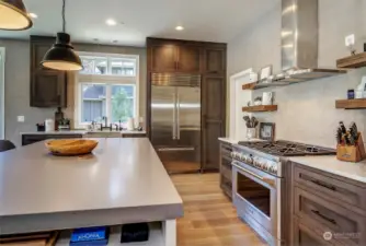 Contemporary kitchen, thick slab quartz counters, Sub-Zero & GE Monogram appliances, 6-burner range & walk-in pantry.