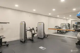 More views of the fitness space highlighting the full-length mirrors and ballet barre.