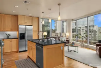 The open layout kitchen boasts an efficient but roomy island with prep sink.