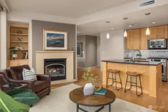 A different perspective of the living space featuring the beautiful built-in shelves and cozy fireplace.