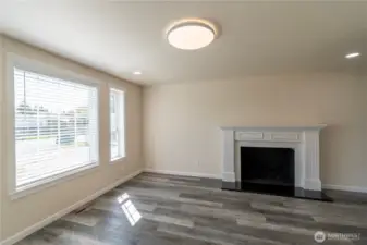 Family room with wood burning fireplace.
