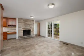 Reverse view of dining room, showing wood burning fireplace