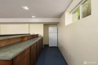 Basement bar area includes refrigerator and sink