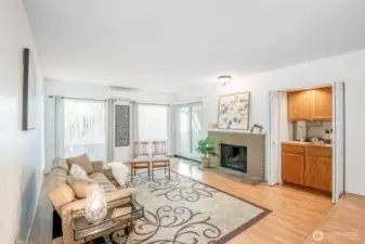 Living room features a cozy fireplace, wet bar, and large windows!