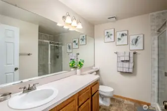 Primary bathroom features a spacious walk-in shower.