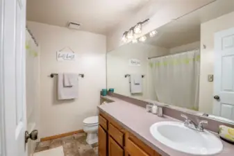 Hallway bathroom boasts a garden tub.