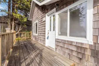 Spacious front deck creates a welcoming entrance—perfect for client access, outdoor seating, or relaxing coastal evenings.
