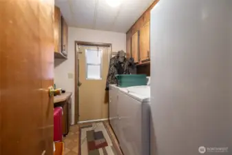 Utility room, washer and dryer will stay with the home.  Entry from the garage/shop area.