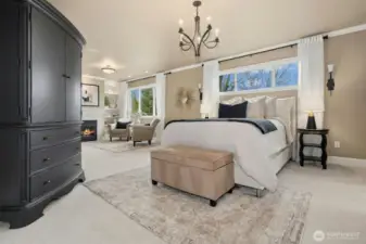 Gracious primary with cozy sitting area and fireplace.