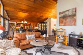 View from the living room across to the fully remodeled kitchen.  The tall cedar ceilings are a beautiful touch.