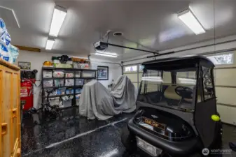 Second garage is currently used for a golf cart, a motorcycle, and storage.  A portion of this garage was remodeled to add the primary walk-in closet and exercise room.